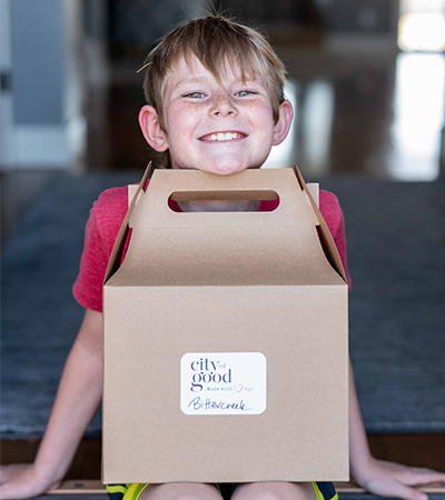 child with box of food